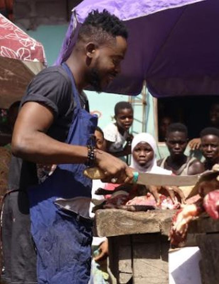 Adekunle Gold Caught Selling Meat Weeks After Working As Bus Conductor (Video + Photos)