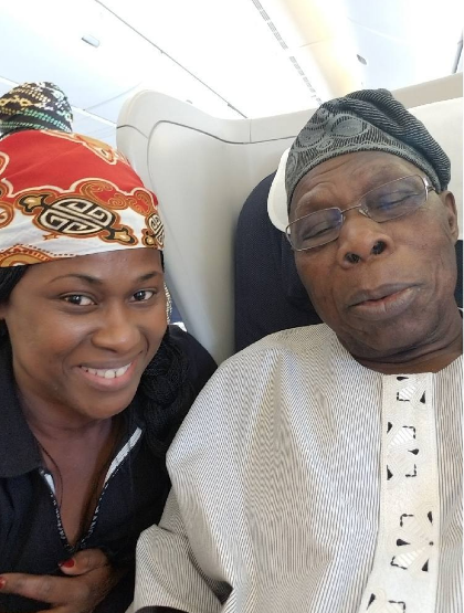 Uche Jombo takes a selfie with Obasanjo on board a flight