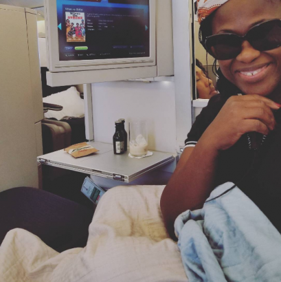 Uche Jombo takes a selfie with Obasanjo on board a flight