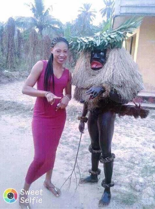 Nigerian Lady Poses With Her Masquerade 'Boyfriend' As He Carries Her (Photos)