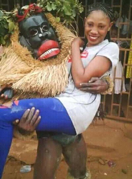 Nigerian Lady Poses With Her Masquerade 'Boyfriend' As He Carries Her (Photos)