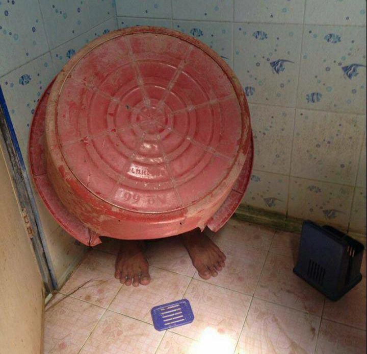 The drug suspect hid under a big bucket when cops raided his Thailand home