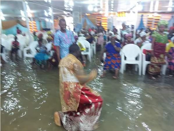 Delta Pastor and His Church Members Seen Worshipping Inside Flooded Church (Photos)