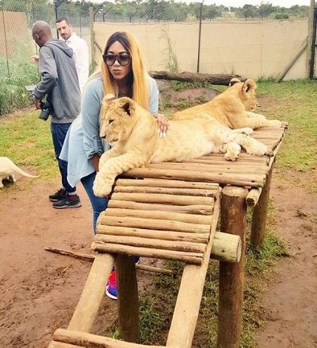 Unbelievable! Nigerian Actress Caught Playing with Lions and Romancing a Snake in South Africa (Videos)