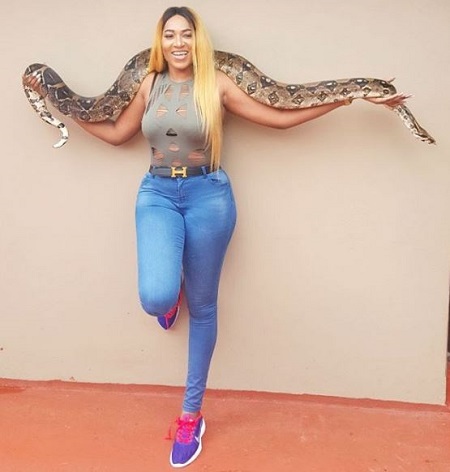 Unbelievable! Nigerian Actress Caught Playing with Lions and Romancing a Snake in South Africa (Videos)