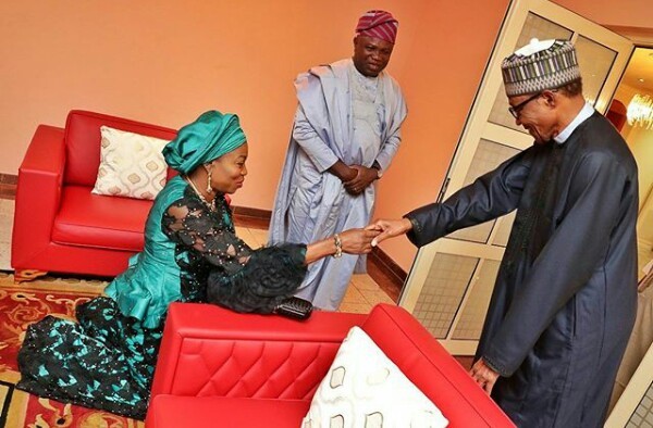 Lagos State first lady, Bolanle Ambode kneels down to greet President Buhari. (Photo)