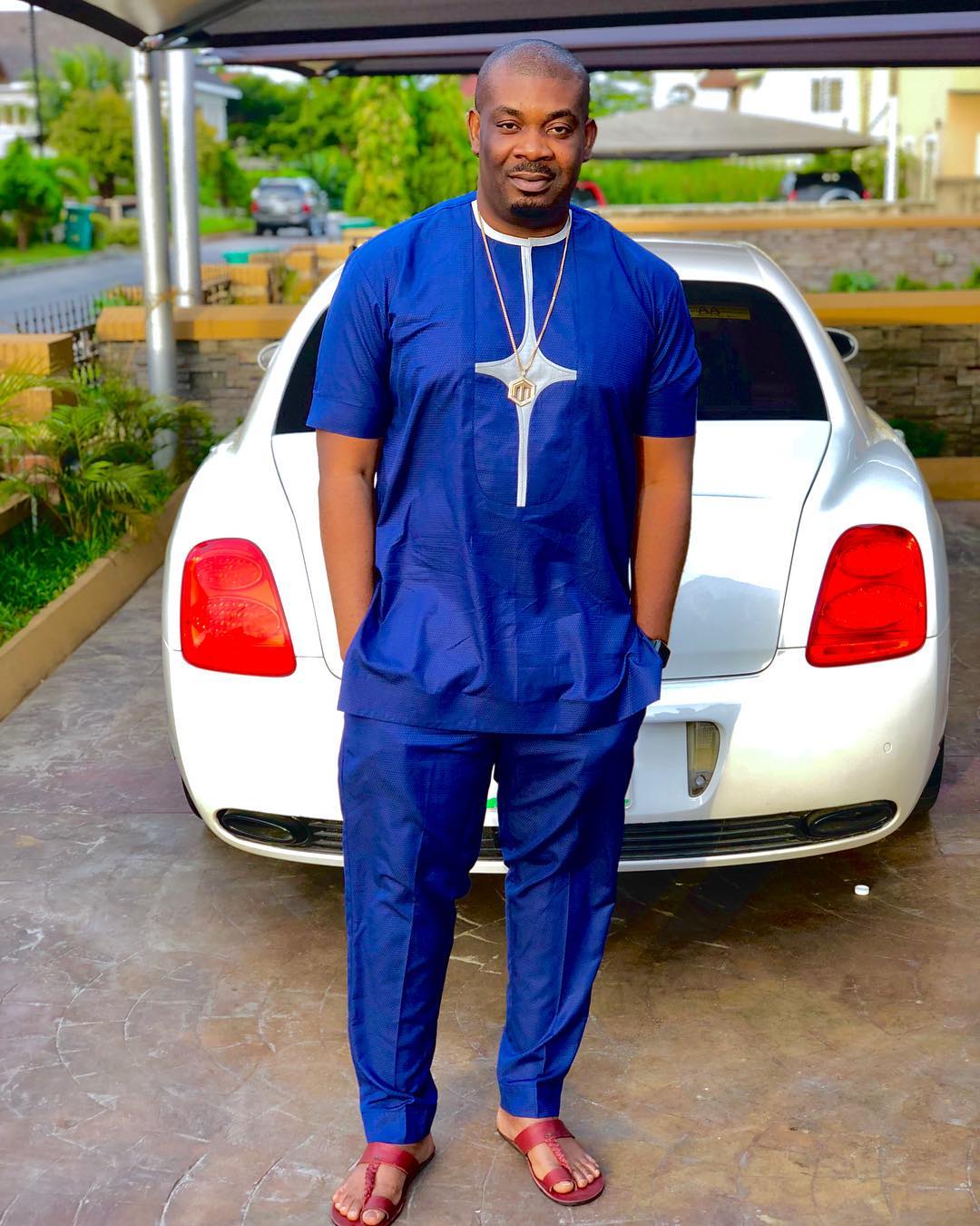 Don Jazzy poses with his white Bentley continental flying spur. (Photo)