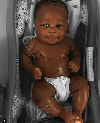 Young African mother celebrates her cute son with really beautiful black skin.