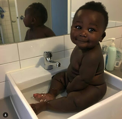 Young African mother celebrates her cute son with really beautiful black skin.