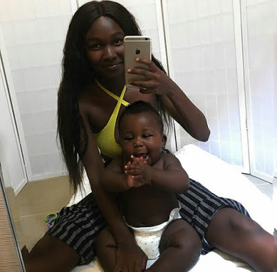 Young African mother celebrates her cute son with really beautiful black skin.