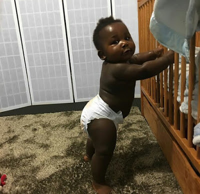 Young African mother celebrates her cute son with really beautiful black skin.