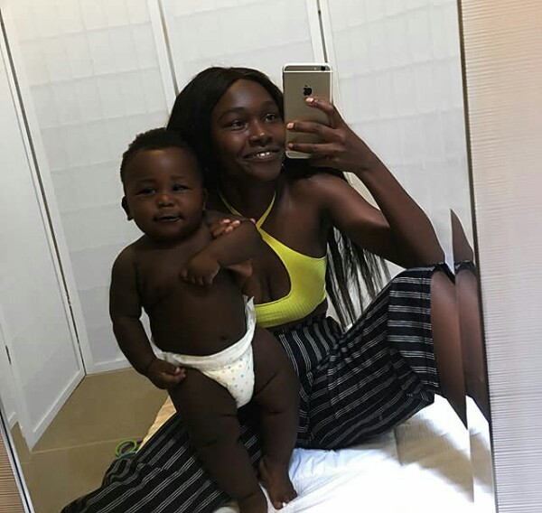 Young African mother celebrates her cute son with really beautiful black skin.