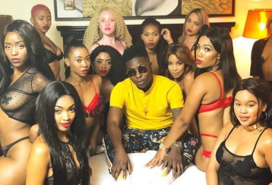 Reekado Banks caught flirtatiously looking at lady's HUGE boobs