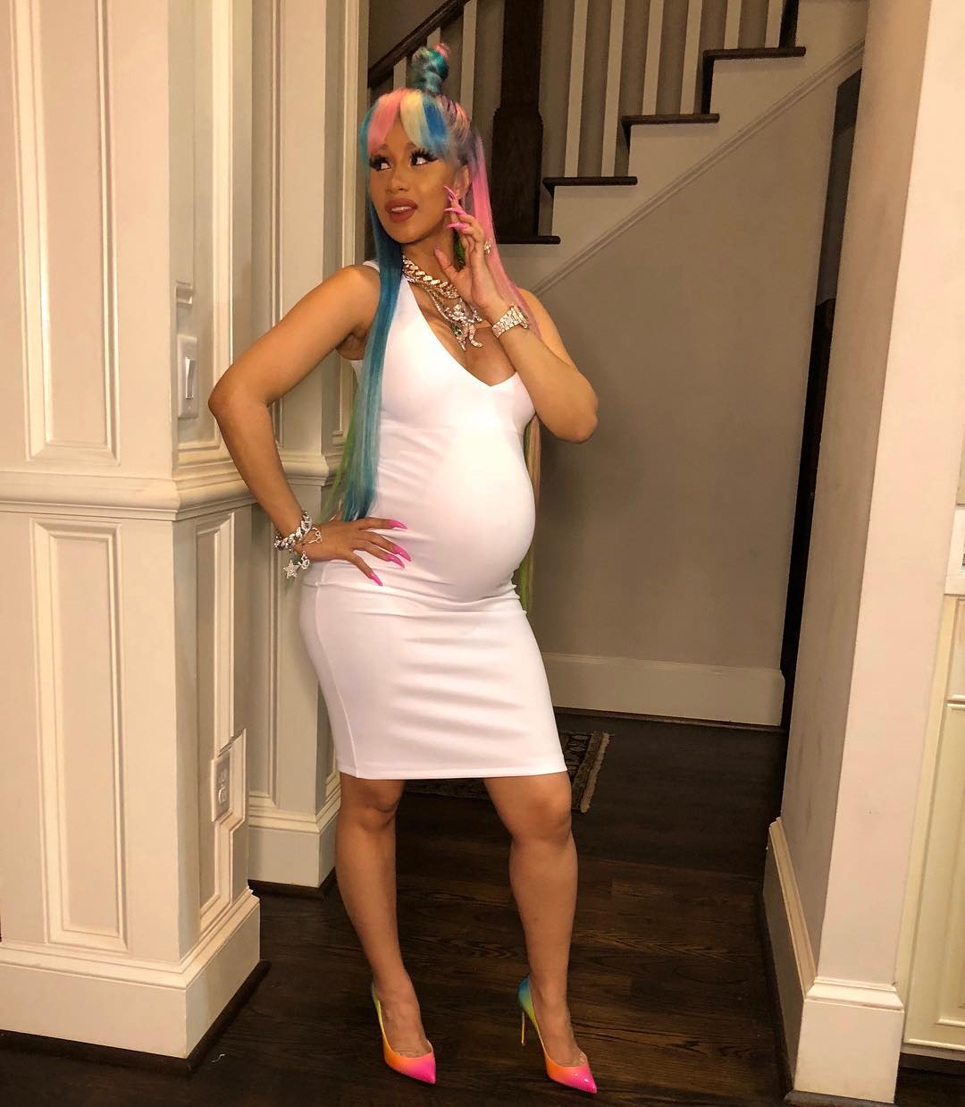 Cardi B matches her hair with her shoe as she shows off her bump at 8 months.
