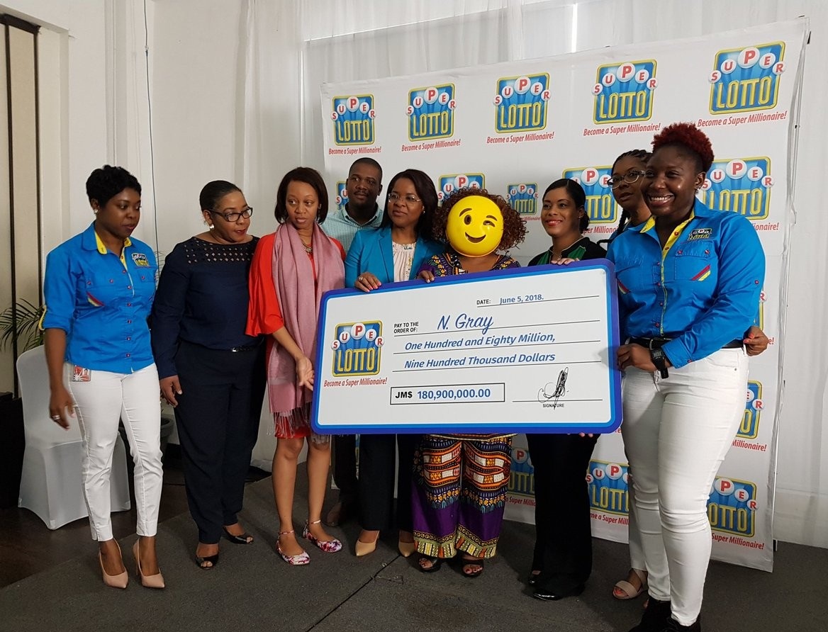 Jamaican lottery winner shows up in a mask to claim her $180 Million prize (Photos)