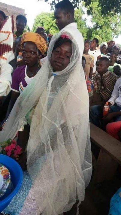 Chai!! Poor Bride Weds Wearing A Mosquito Net And Bag Of Rice As Her Wedding Gown