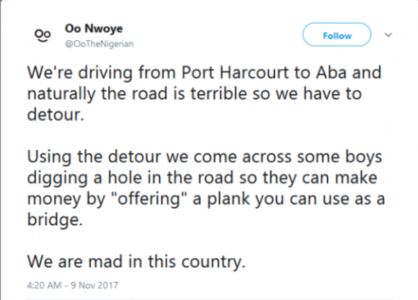 Nigerian Youths Dig Hole In The Road So Motorists Can Pay For Their Plank To Be Used As Bridge