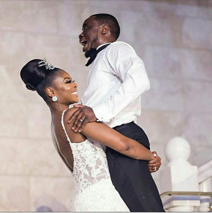 Bride Lifts Groom Up After Kissing Him At Their Wedding Reception (Photo)