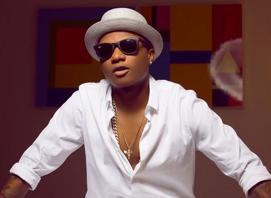 Fans Scream As Wizkid Tries To Jump Off From A High Hill Van (Video)