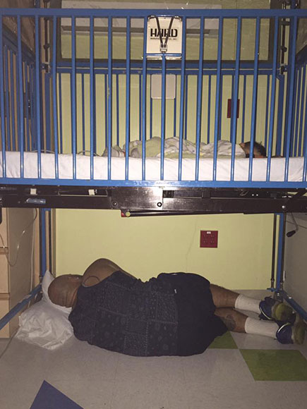 Touching photo of a father sleeping under sick son's hospital bed goes viral