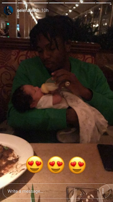 Daddy Duties! Runtown Pictured Bottle Feeding His Son