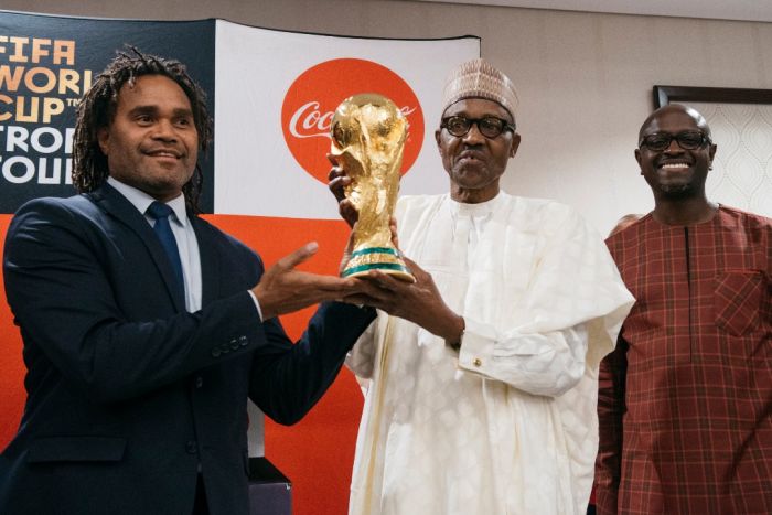 Photos:- The Moment The FIFA World Cup Trophy Was Lifted By The President Of Nigeria