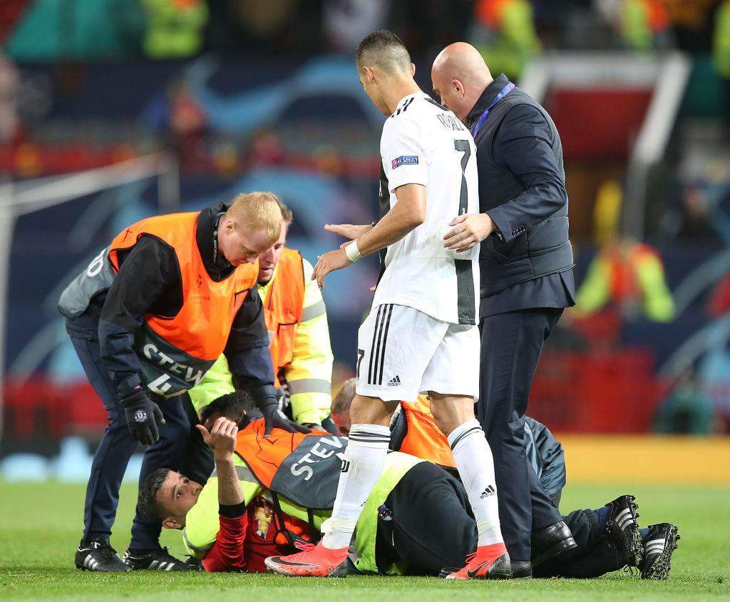 Cristiano Ronaldo takes selfie with pitch-invading fan moments after Juventus' Champions League victory over Manchester United