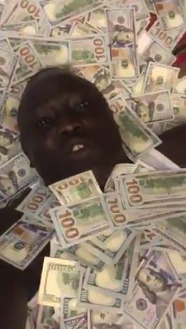 Another Hushpuppi, South Sudanese socialite shows off wads of dollar bills he claims is over $1m
