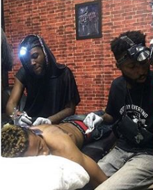 Man Gets Wizkid And Davido's Tattoos On His Back In Abuja (Photos)