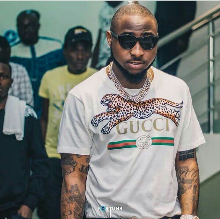 Davido slams fan who called him a kid for flaunting his wealth, Burna boy reacts