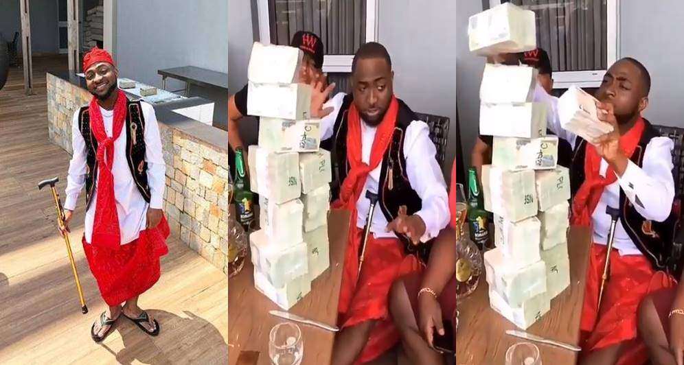Davido stacks up wads of cash to be sprayed at a wedding in Imo state (Video)