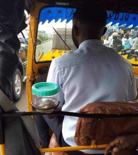 'Corporate keke driver' who has sweets and his business card in his tricycle for passengers goes viral (photos)