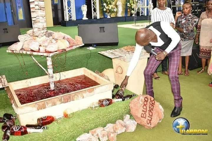 Pastor feeds his church members millipede and beer (photos)