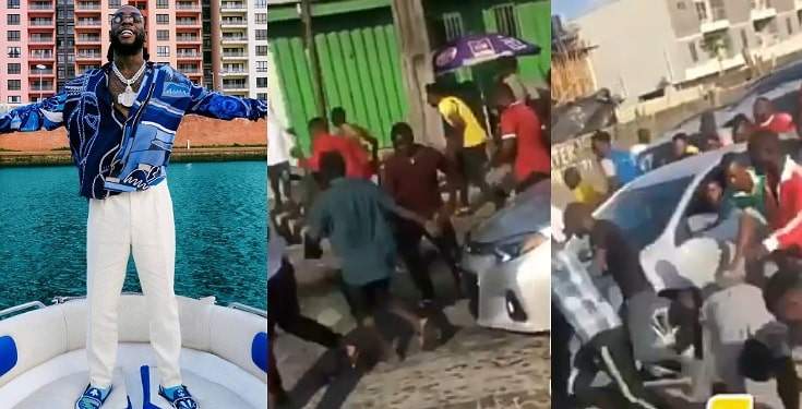 Nigerians fall on themselves as they struggle to pick money thrown by Burna Boy (Video)