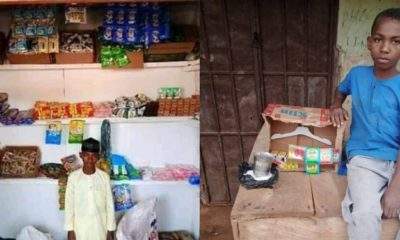 Primary school pupil poses in front of his "Shopping Complex" in Kano