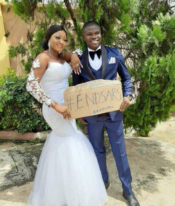 Newly wedded couple use #EndSARS placard in wedding photos
