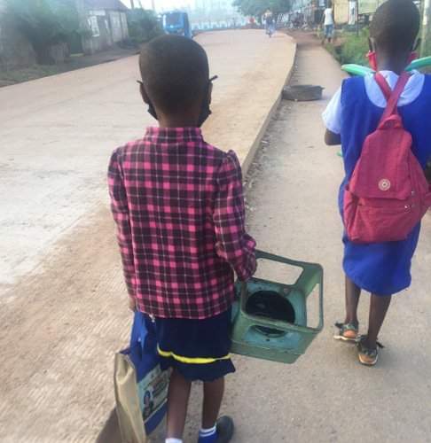 Picture of a student going to school with a stove frame to be used as a chair in class sparks outrage online