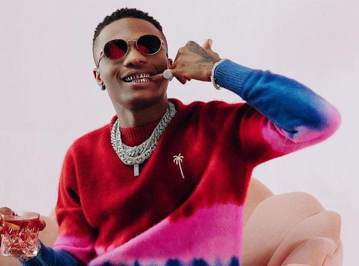 Wizkid reacts as die-hard fan tattoos his face on his arm (Video)