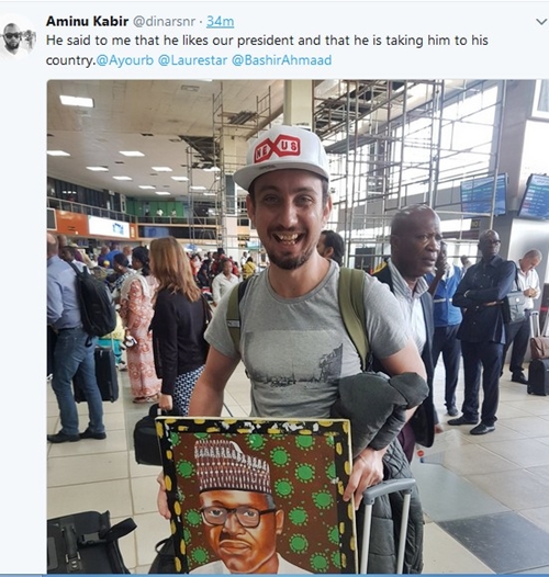 I Like President Buhari, I Am Taking Him To My Country- Foreigner Spotted With President Buhari's Painting