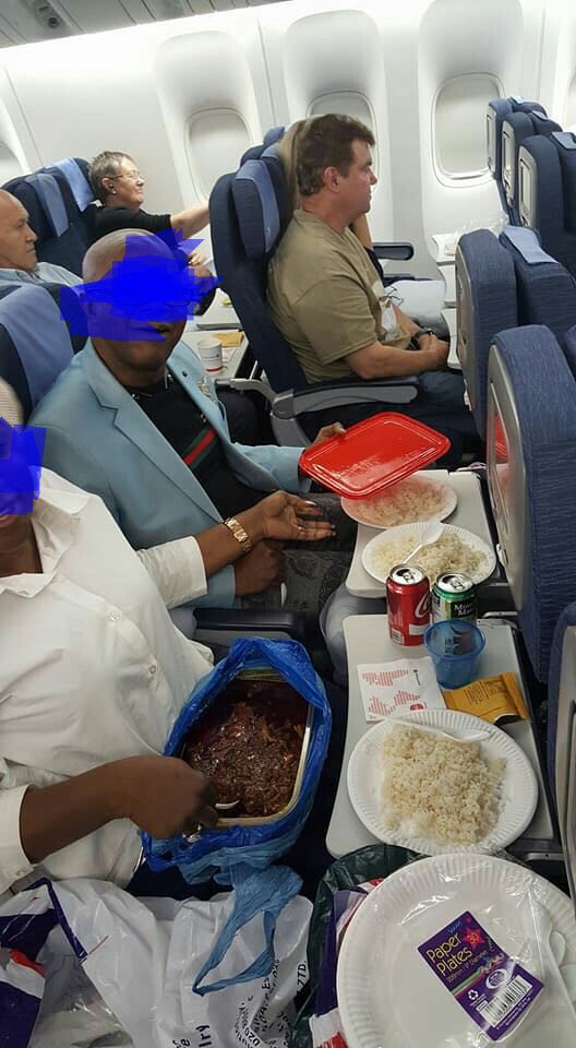 Photo Of A Nigerian Couple Eating Rice And Ofada Stew During A Flight