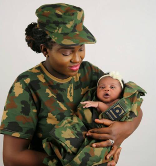 Beautiful photo of a Female Nigerian soldier cradling her newborn baby