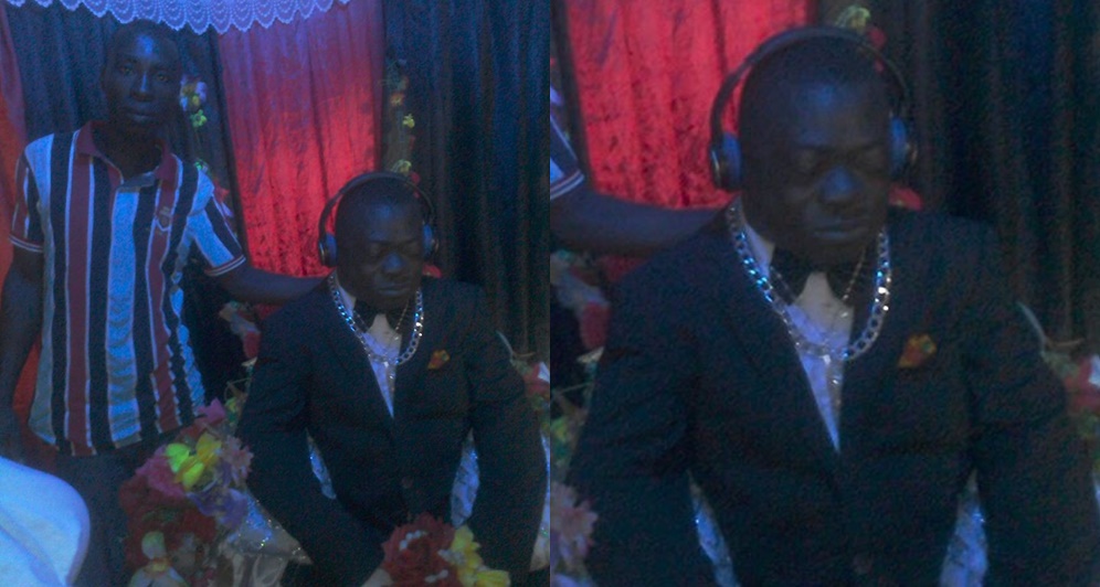 Dead Man Dressed In Suit With Silver Chain And Headset For His Burial