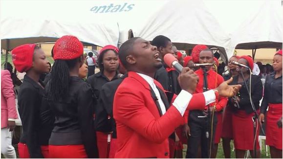 Nigerians react to photos of Choir Master with a scantily-clad Lady
