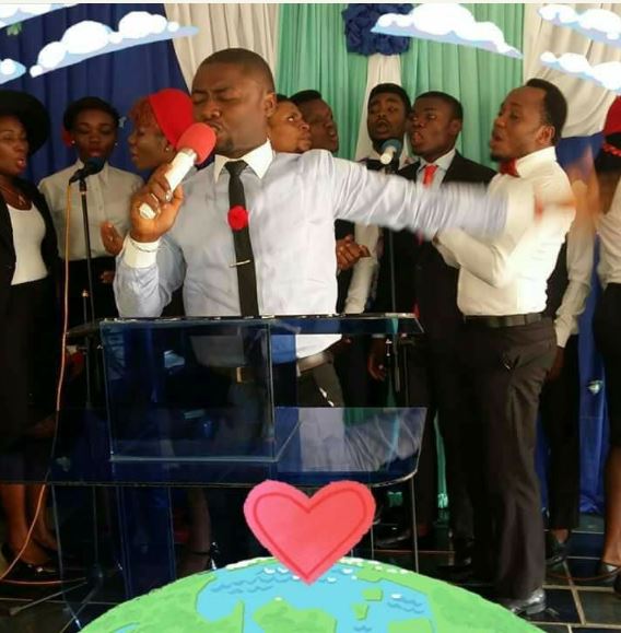 Nigerians react to photos of Choir Master with a scantily-clad Lady