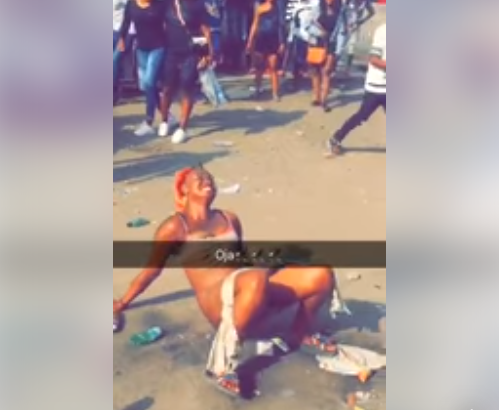 Lady strips off in the middle of a road in Mushin, Lagos (photos)