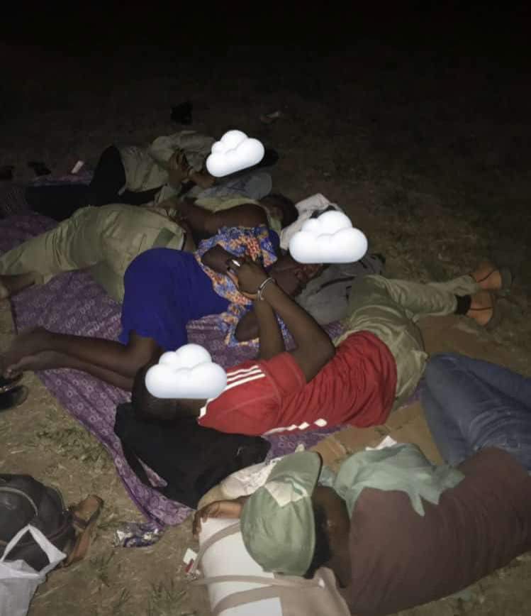 Disturbing Photos Of INEC Ad-hoc Staff, Corpers Sleeping Outside Its Premises