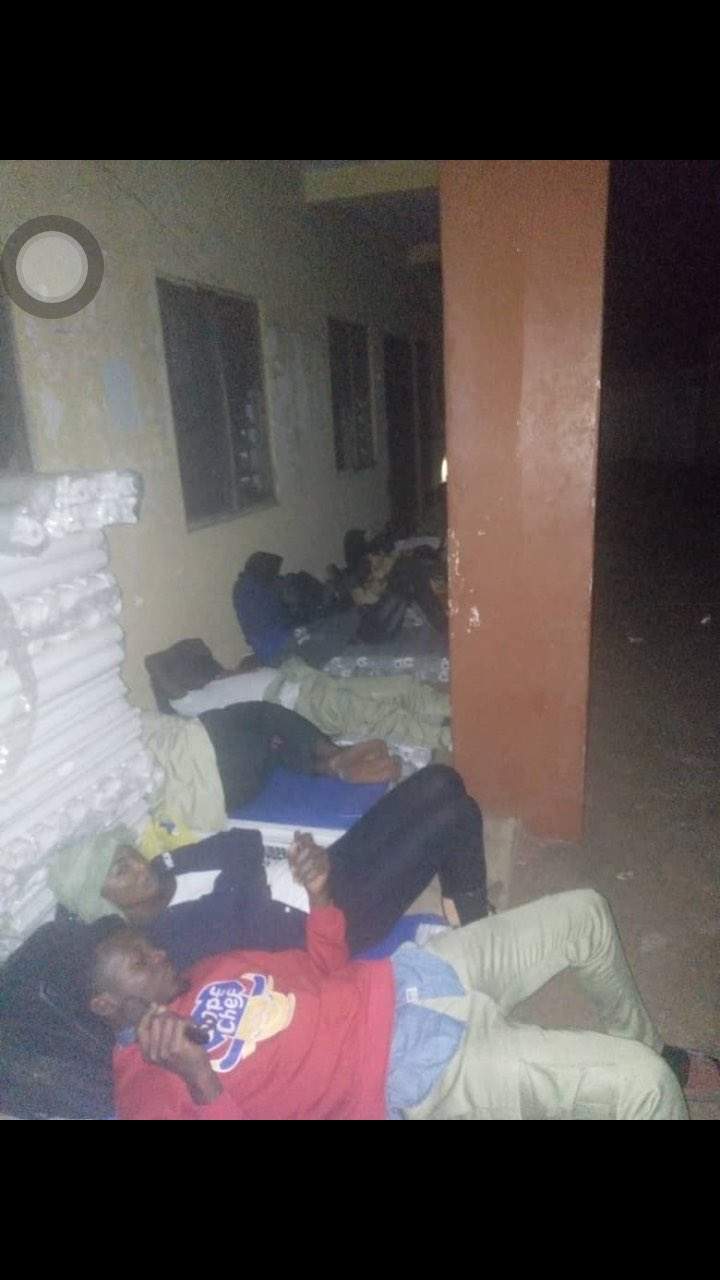 Disturbing Photos Of INEC Ad-hoc Staff, Corpers Sleeping Outside Its Premises