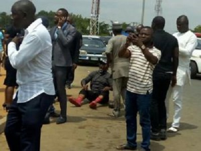 Photo Of Dino Melaye Sitting On The Floor While Resisting Police Arrest
