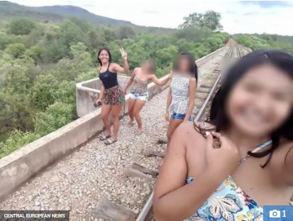 The women were posing for selfies when the bridge suddenly gave way