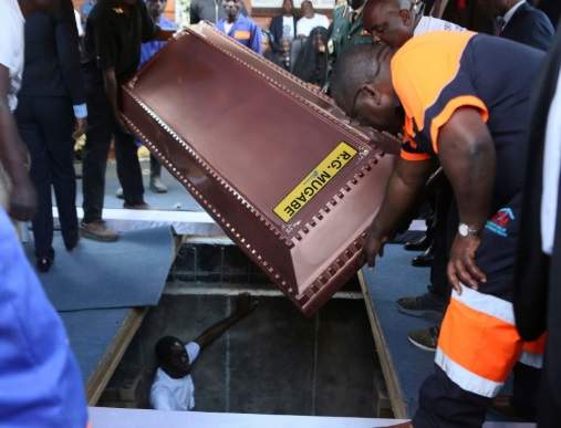 Robert Mugabe buried in steel coffin encased in concrete as family claims people are 'after his body'